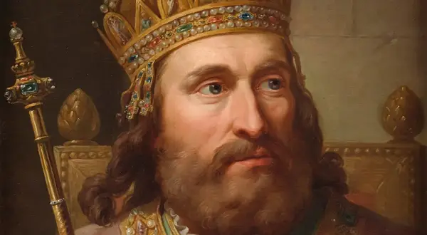 Portret króla w bogatej koronie i z berłem, symbolizujący jego koronację i władzę.